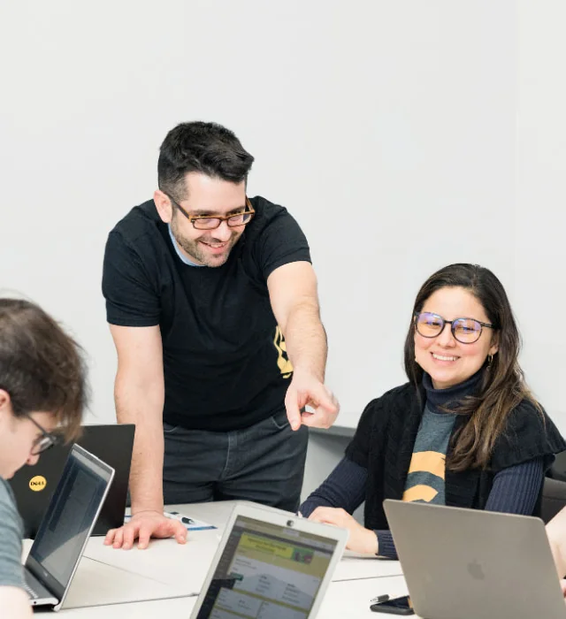 Graphem team members working together on laptops in the Vancouver office